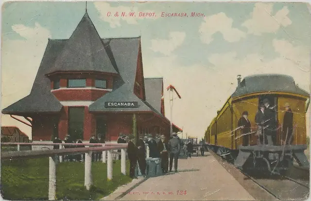 UP Escanaba MI RR1908 C&NW DEPOT Chicago and Northwestern Railroad LUMBER DAYS MINING AND EXOTIC TRAVEL DESTINATION Wagons Buggys Dirt Stree